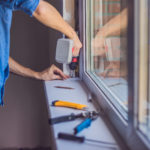 Man,In,A,Blue,Shirt,Does,Window,Installation.